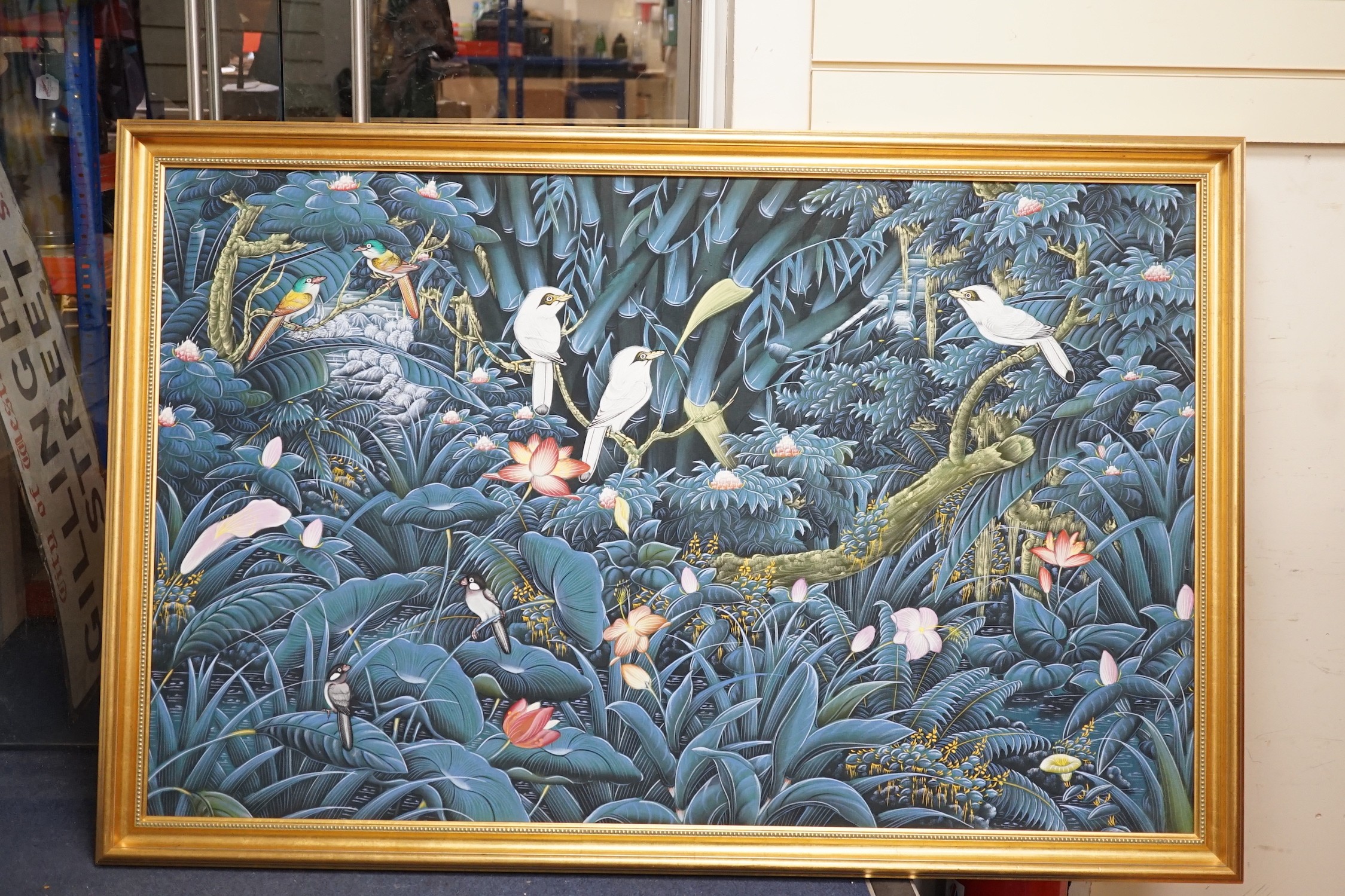 A modern Batik painting of birds amongst trees and flowers, 82 x 131cm